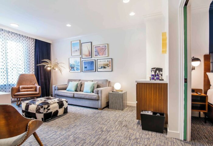 Hotel Belmont Vancouver Mgallery room. Gay-friendly hotel with stylish decor, seating area, and a glimpse into the bedroom.