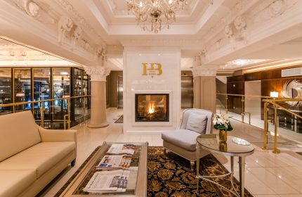 Hotel Birks Montreal's luxurious lobby. Fireplace, seating area, and ornate details create an inviting ambiance. Gay-friendly hotel.