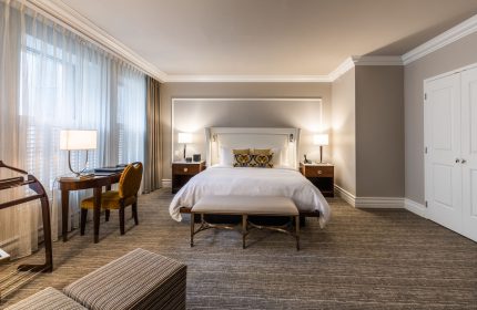 Hotel Birks Montreal guest room. Gay-friendly hotel with a king bed, desk, and neutral decor. Upscale lodging for gay travelers.