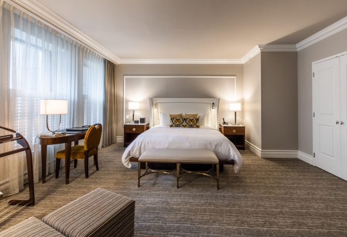 Hotel Birks Montreal guest room. Gay-friendly hotel with a king bed, desk, and neutral decor. Upscale lodging for gay travelers.