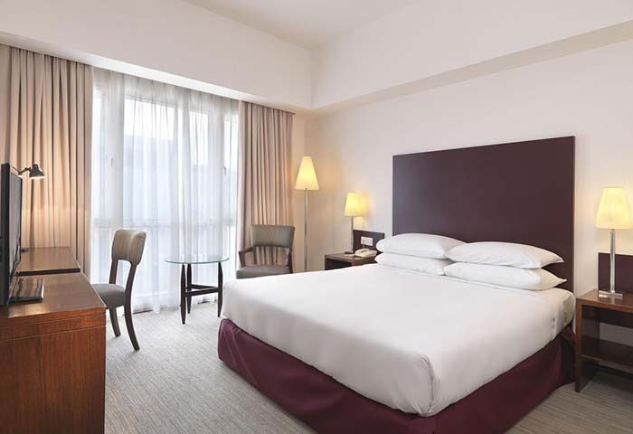 Hotel Capitol Kuala Lumpur gay-friendly room. King bed, desk, & chair. Modern decor, warm lighting. Perfect for gay travelers in Kuala Lumpur.