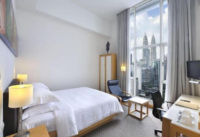 Hotel Capitol Kuala Lumpur room with a view. Gay-friendly hotel with modern decor, a comfy bed, and a city view including the Petronas Towers.