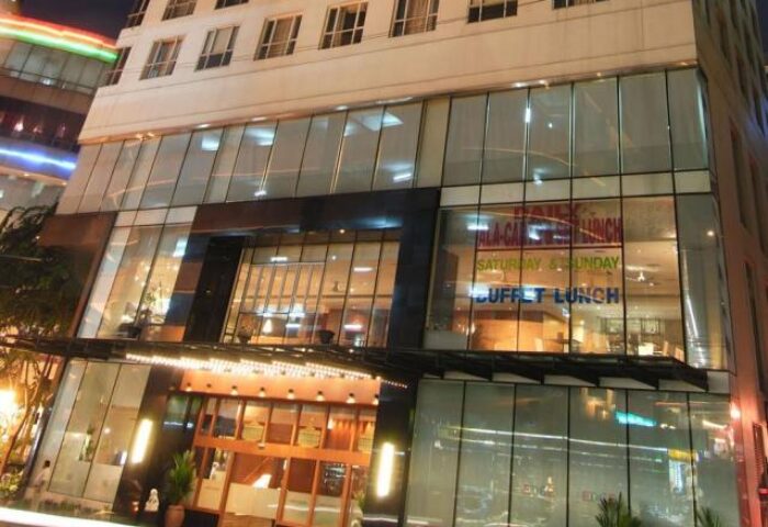 Hotel Capitol Kuala Lumpur facade. Gay-friendly hotel with modern glass design. Buffet lunch advertised. A great choice for gay travelers.