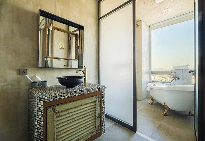 Hotel Cappuccino Seoul bathroom. Stylish sink, mirror, and bathtub with a view. Gay-friendly hotel design. Seoul travel.