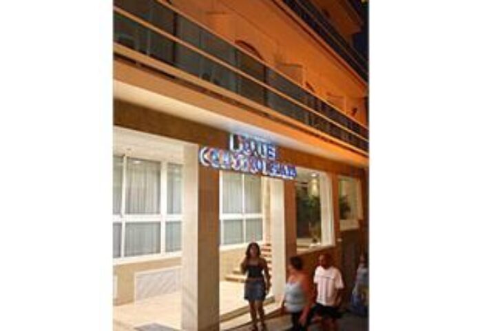 Hotel Centro Mar, a gay-friendly hotel. Exterior view of the hotel entrance with people. A welcoming space for gay travelers.