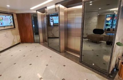Hotel Century Reforma lobby area with elevators. Gay-friendly hotel interior, marble floors, and modern design elements. Gay men travel advice.