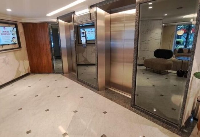 Hotel Century Reforma lobby area with elevators. Gay-friendly hotel interior, marble floors, and modern design elements. Gay men travel advice.
