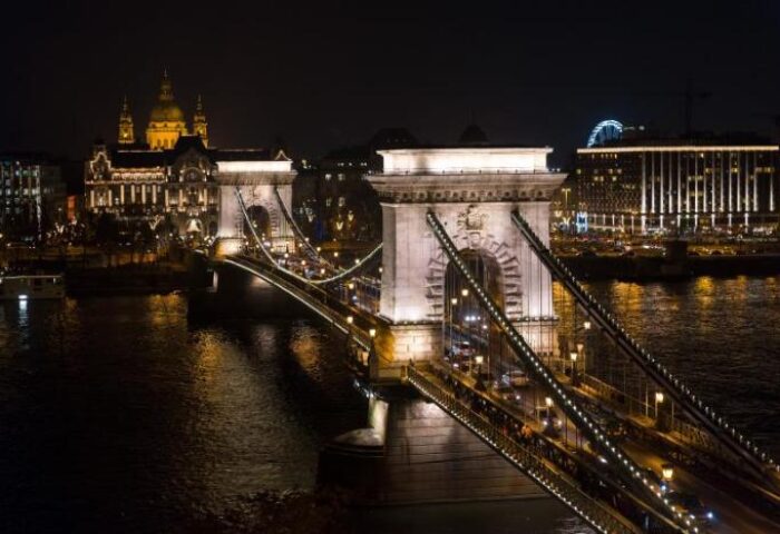 Night view of Budapest's Széchenyi Chain Bridge and city lights. Gay-friendly Hotel Clark Budapest is nearby, a pet-friendly choice for gay travelers.