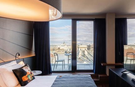 Hotel Clark Budapest room. Gay-friendly, pet-friendly hotel with Danube River view. Balcony with table and chairs. Modern design, luxury.