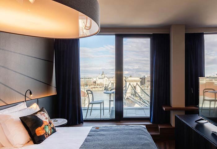 Hotel Clark Budapest room. Gay-friendly, pet-friendly hotel with Danube River view. Balcony with table and chairs. Modern design, luxury.