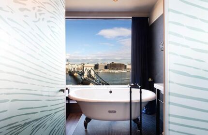Hotel Clark Budapest bathroom with a view. The gay-friendly, pet-friendly hotel offers unique rooms overlooking the Danube and Chain Bridge.