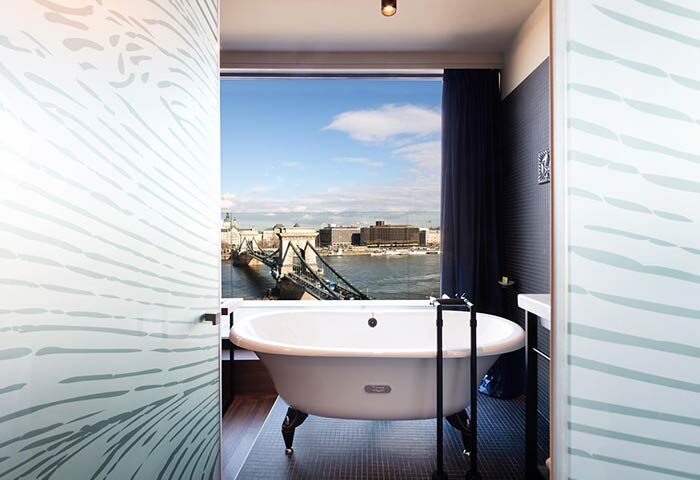 Hotel Clark Budapest bathroom with a view. The gay-friendly, pet-friendly hotel offers unique rooms overlooking the Danube and Chain Bridge.