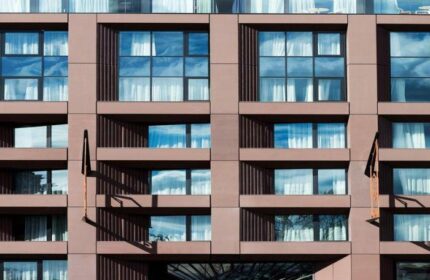 Hotel Clark Budapest facade. Modern architecture with windows reflecting the sky. Gay-friendly, pet-friendly hotel in Budapest.