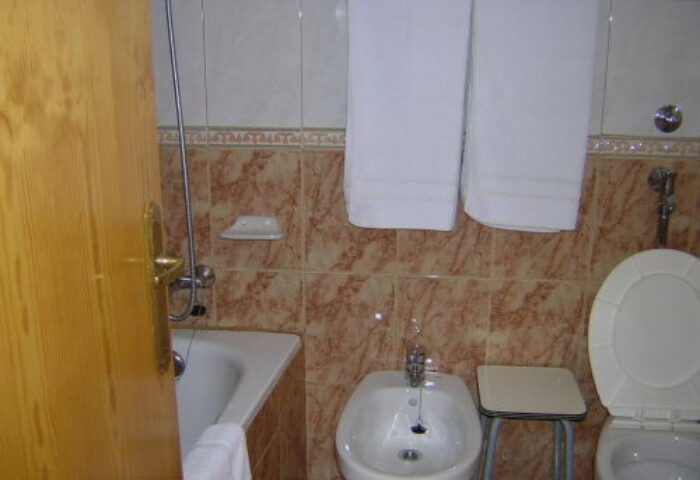 Hotel Condestable bathroom. Gay-friendly hotel room with bidet, toilet, shower, and towels. Gay travel accommodations.