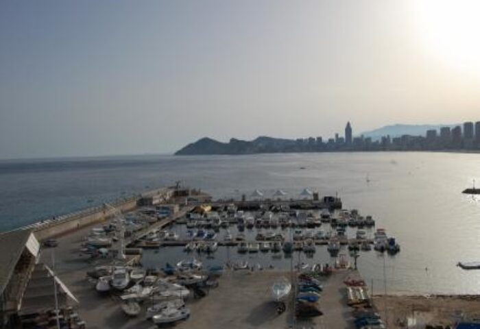 Hotel Condestable view: boats in harbor, city skyline. Gay-friendly travel advice for Benidorm.