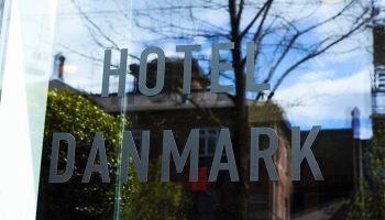 Hotel Danmark by Brøchner Hotels entrance. Gay-friendly hotel with Hotel Danmark signage on glass. A top choice for gay travel.