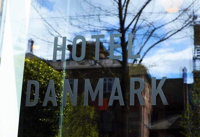 Hotel Danmark by Brøchner Hotels entrance. Gay-friendly hotel with Hotel Danmark signage on glass. A top choice for gay travel.