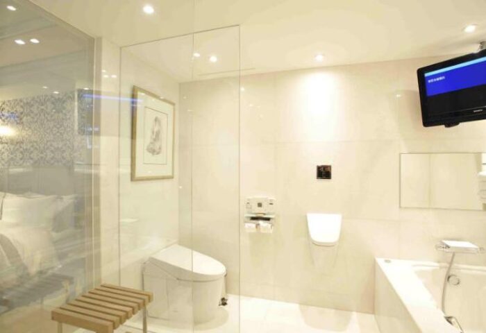 Hotel Eclat Taipei gay-friendly hotel bathroom. Toilet, bidet, bathtub, and TV. Luxury hotel room for gay men travelers in Taipei.