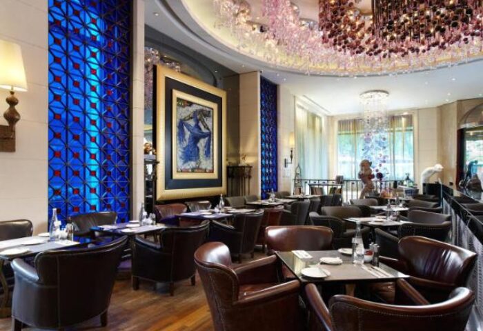 Hotel Eclat Taipei's gay-friendly dining area. Upscale restaurant with leather chairs, modern art, and chandeliers. Taipei luxury travel.