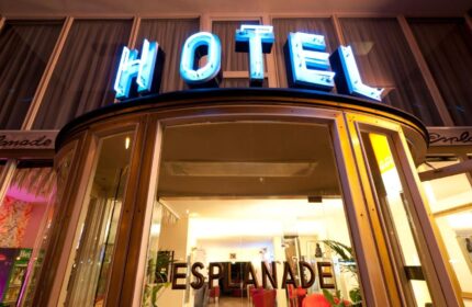 Hotel Esplanade Köln entrance. Gay-friendly hotel with neon HOTEL sign. A great choice for gay men traveling to Cologne, Germany.