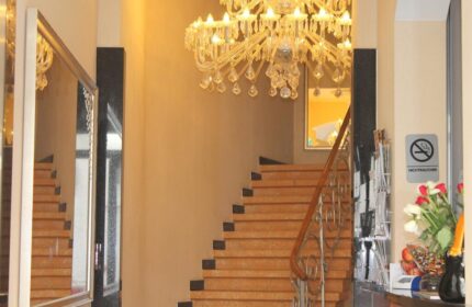 Hotel Expo Frankfurt City Centre's elegant staircase with a chandelier. Gay-friendly hotel with a non-smoking area. Perfect for gay travel.