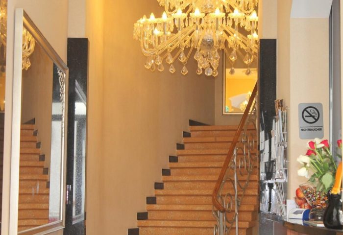 Hotel Expo Frankfurt City Centre's elegant staircase with a chandelier. Gay-friendly hotel with a non-smoking area. Perfect for gay travel.