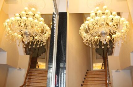 Hotel Expo Frankfurt City Centre's gay-friendly ambiance: Grand chandeliers illuminate the staircase, reflecting luxury for gay travelers.