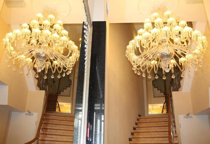 Hotel Expo Frankfurt City Centre's gay-friendly ambiance: Grand chandeliers illuminate the staircase, reflecting luxury for gay travelers.