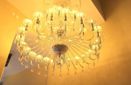 Ornate chandelier at the Gay-Friendly Hotel Expo Frankfurt City Centre. Elegant lighting fixture with crystal details. Upscale hotel ambiance.