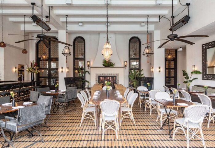 Hotel Figueroa, In The Unbound Collection By Hyatt, gay-friendly hotel. Restaurant with fireplace, tables, chairs, and plants.