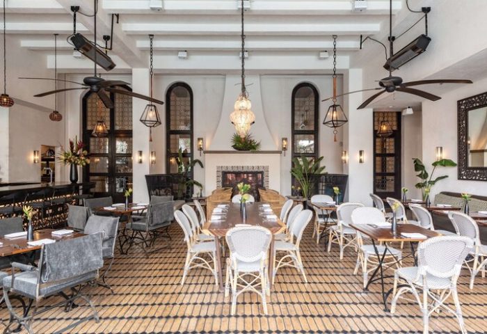 Hotel Figueroa, In The Unbound Collection By Hyatt, gay-friendly hotel. Restaurant with fireplace, tables, chairs, and plants.