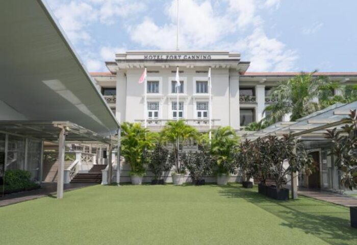 Exterior of Hotel Fort Canning, a gay-friendly hotel in Singapore, showcasing its colonial architecture and lush greenery. A perfect gay travel destination.