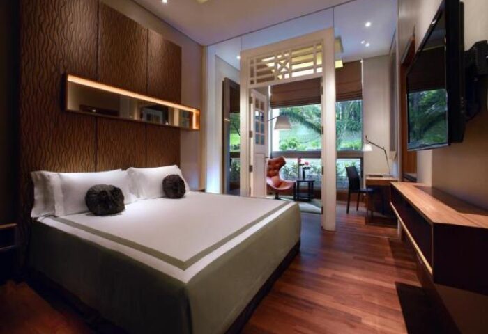 Hotel Fort Canning gay-friendly hotel room. Bedroom with king bed, desk, and balcony. Great for gay travelers. Singapore hotel.