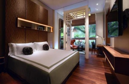 Hotel Fort Canning gay-friendly hotel room. Bedroom with king bed, desk, and balcony. Great for gay travelers. Singapore hotel.