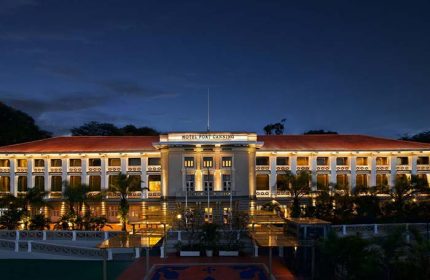 Hotel Fort Canning, a gay-friendly hotel in Singapore. Exterior view of the hotel at night, showcasing its architecture and illuminated facade.