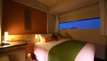 Hotel Gracery Shinjuku gay-friendly room. Modern design, warm lighting, city view. Perfect for gay travel in Tokyo's vibrant Shinjuku district.