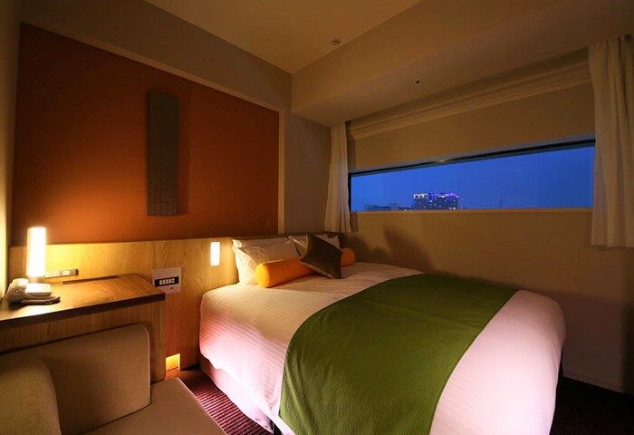 Hotel Gracery Shinjuku gay-friendly room. Modern design, warm lighting, city view. Perfect for gay travel in Tokyo's vibrant Shinjuku district.