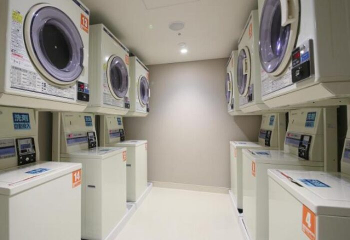 Hotel Gracery Shinjuku's laundry room. Washers and dryers line the walls in this gay-friendly hotel, offering convenient laundry facilities.