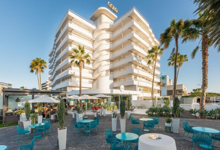 Gold Playa del Ingles Adults Only hotel exterior. Gay-friendly Gran Canaria Princess hotel with palm trees and outdoor seating.