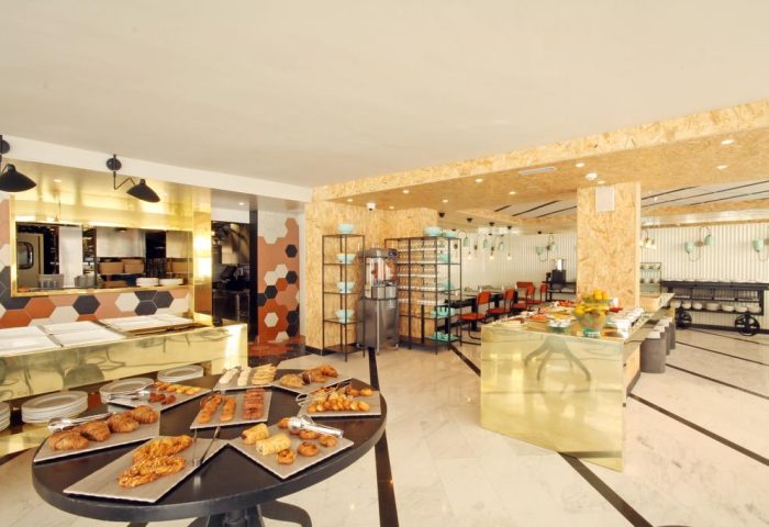 Buffet at Gold Playa del Ingles, Adults Only gay-friendly hotel in Gran Canaria. Breakfast pastries, golden counters, and modern design.