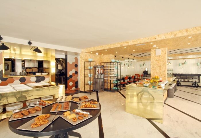 Buffet at Gold Playa del Ingles, Adults Only gay-friendly hotel in Gran Canaria. Breakfast pastries, golden counters, and modern design.