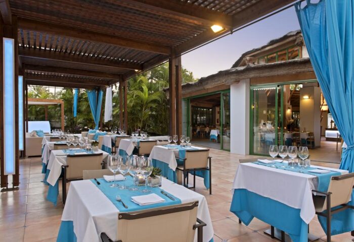 Hotel Gran Canaria Princess Adults Only gay-friendly hotel outdoor dining area. Tables set with blue accents, creating a relaxed atmosphere.