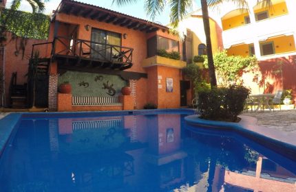 Hotel Hacienda Maria Bonita, a gay-friendly hotel. View of the pool and the hacienda-style architecture. A great place for gay travelers.
