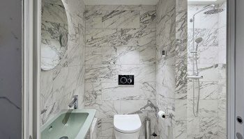 Hotel Herman K by Brøchner Hotels bathroom. Marble tiles, sink, toilet, and shower. Gay-friendly hotel for gay men travel.