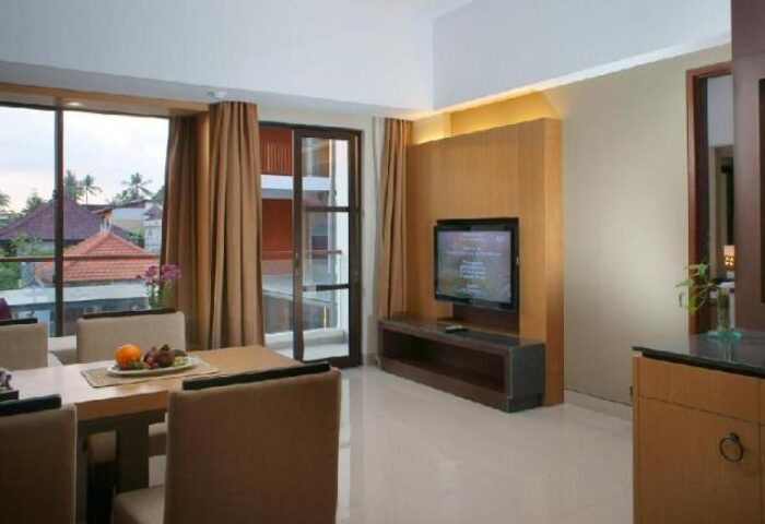 Horison Seminyak Bali gay-friendly hotel room interior. Dining table, TV, and balcony. A great choice for gay travelers in Bali.