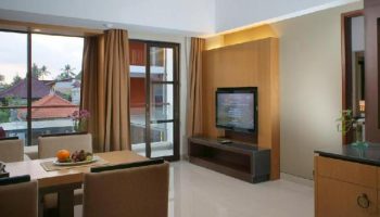 Horison Seminyak Bali gay-friendly hotel room interior. Dining table, TV, and balcony. A great choice for gay travelers in Bali.
