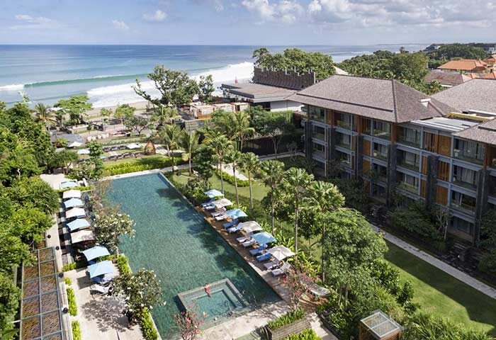 Hotel Indigo Bali Seminyak Beach aerial view. Gay-friendly hotel with pool, beach access, and lush greenery. Perfect for gay travelers.