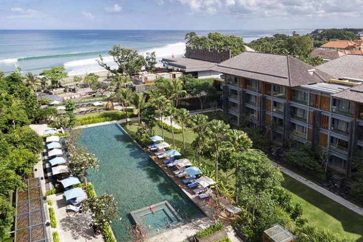 Hotel Indigo Bali Seminyak Beach aerial view. Gay-friendly hotel with pool, beach access, and lush greenery. Perfect for gay travelers.