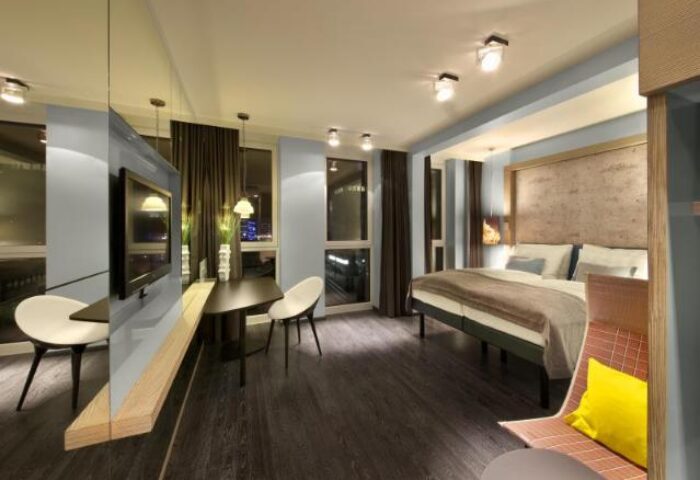 Hotel Indigo Berlin-Alexanderplatz room. Modern design, bed, table, chairs. Gay-friendly hotel, great for LGBTQ+ travelers in Berlin.
