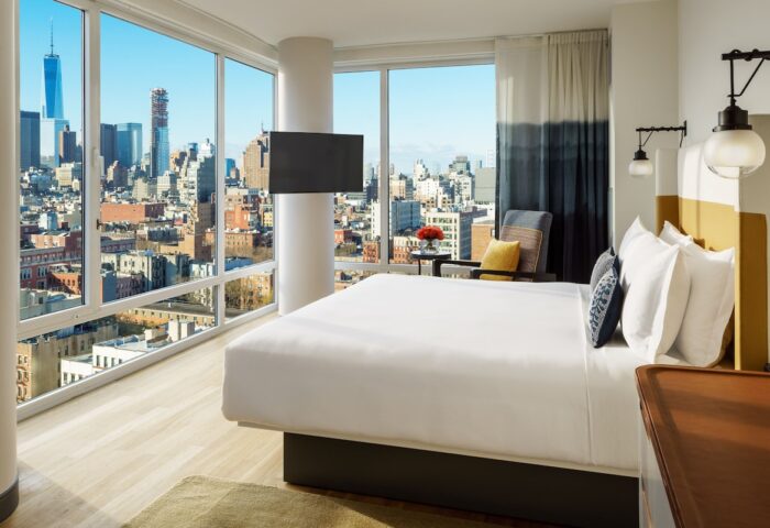 Hotel Indigo Lower East Side gay-friendly hotel room with city view. Modern design, large windows, comfortable bed. Perfect for gay travel.